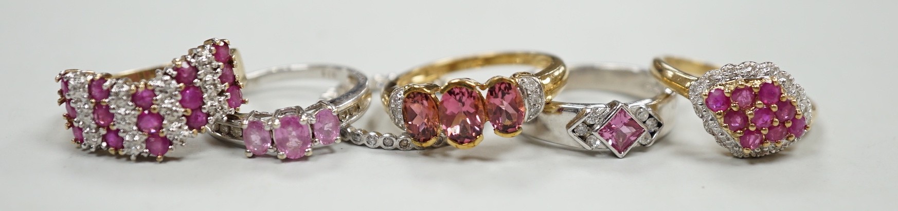 Five assorted modern 9ct gold and gem set dress rings, gross weight 16.7 grams and one other white metal and gem set eternity ring.